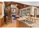Open-concept living space with stone fireplace, vaulted ceiling, and hardwood floors at 13037 Overlook Pass, Roswell, GA 30075