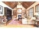 Cozy living room featuring a vaulted wood ceiling, fireplace, and built-in bookshelves at 13037 Overlook Pass, Roswell, GA 30075