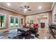 Comfortable living room with cow hide rug, leather sofa, ottoman and an adjacent dining area at 13037 Overlook Pass, Roswell, GA 30075