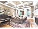 Bright living room featuring a fireplace, large windows, and classic decor at 13037 Overlook Pass, Roswell, GA 30075