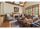 Cozy living room with a fireplace, wood paneling, and vaulted ceilings with fan at 13037 Overlook Pass, Roswell, GA 30075