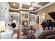 Cozy living room featuring custom built-ins, fire place, and coffered ceilings at 13037 Overlook Pass, Roswell, GA 30075