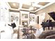 Elegant living room with coffered ceiling, fireplace, built-in bookcases, and a grand piano at 13037 Overlook Pass, Roswell, GA 30075