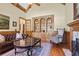 Living room featuring hardwood floors, fireplace, built-in bookcase and comfortable seating at 13037 Overlook Pass, Roswell, GA 30075