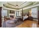 Spacious main bedroom suite with tray ceiling, fireplace, sitting area, and hardwood floors at 13037 Overlook Pass, Roswell, GA 30075