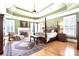 Elegant bedroom featuring a four-poster bed, fireplace, and tray ceiling with fan at 13037 Overlook Pass, Roswell, GA 30075