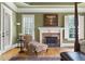 Elegant main bedroom with a fireplace, hardwood floors, and ample natural light from large windows at 13037 Overlook Pass, Roswell, GA 30075