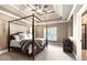 Spacious main bedroom with four poster bed and tray ceiling and an en-suite bathroom with glass shower door at 13037 Overlook Pass, Roswell, GA 30075