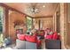 Cozy brick patio with stone fireplace, ceiling fan, and comfortable seating area for outdoor enjoyment at 13037 Overlook Pass, Roswell, GA 30075