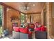 Inviting brick patio featuring a fireplace, comfortable seating, and a ceiling fan for outdoor relaxation at 13037 Overlook Pass, Roswell, GA 30075