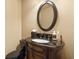 Cozy powder room features a vessel sink, black countertop and a decorative mirror at 13037 Overlook Pass, Roswell, GA 30075