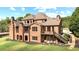 Brick home's exterior showcasing balconies, a staircase, and landscaped backyard at 13037 Overlook Pass, Roswell, GA 30075