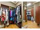 Well-organized walk-in closet with rods, shelves, and full-length mirror for all your wardrobe needs at 13037 Overlook Pass, Roswell, GA 30075