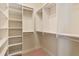 A well-organized walk-in closet with built-in shelving for optimal storage at 13037 Overlook Pass, Roswell, GA 30075