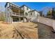 A spacious backyard showcases a covered porch, exposed aggregate patio, and a brick retaining wall at 375 Chattahoochee St, Roswell, GA 30075