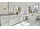 Elegant bathroom with double vanities, marble countertops, freestanding tub, and natural light at 375 Chattahoochee St, Roswell, GA 30075