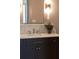 Modern bathroom vanity with marble countertop, stylish fixtures, and a sleek rectangular mirror at 375 Chattahoochee St, Roswell, GA 30075