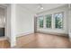 Bright bedroom with hardwood floors, three large windows offering natural light, and neutral color scheme at 375 Chattahoochee St, Roswell, GA 30075