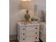 Charming bedroom nightstand with decorative lamp and flowers, a cozy retreat at 375 Chattahoochee St, Roswell, GA 30075