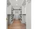 Spacious walk-in closet with custom shelving, drawers, and ample storage space at 375 Chattahoochee St, Roswell, GA 30075