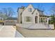 An impressive home features a brick facade, a large front porch, and manicured landscaping at 375 Chattahoochee St, Roswell, GA 30075