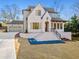 A stately home boasts a brick facade, black frame windows, and meticulous landscaping at 375 Chattahoochee St, Roswell, GA 30075