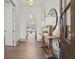 Bright foyer with hardwood floors, elegant lighting, console table, and arched doorways leading to other rooms at 375 Chattahoochee St, Roswell, GA 30075