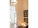 Close-up of foyer showcasing decorative art, sconces, and table with decorative lamps at 375 Chattahoochee St, Roswell, GA 30075