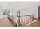 Second floor hallway with wood floors and a decorative light fixture at 375 Chattahoochee St, Roswell, GA 30075