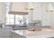 Bright kitchen with white cabinetry, marble countertops, and stainless steel appliances at 375 Chattahoochee St, Roswell, GA 30075