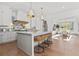 Modern open concept kitchen with stainless steel appliances and seating area at 375 Chattahoochee St, Roswell, GA 30075