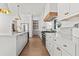 Modern kitchen features white cabinetry, marble countertops, and stainless steel appliances at 375 Chattahoochee St, Roswell, GA 30075