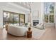Bright living room with high ceilings, large windows, fireplace, and cozy seating area at 375 Chattahoochee St, Roswell, GA 30075