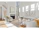 Bright living room features a fireplace, high ceilings, large windows, and elegant decor at 375 Chattahoochee St, Roswell, GA 30075