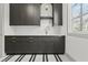Chic mudroom with gray cabinets, white countertop and black and white stripe-patterned tile at 375 Chattahoochee St, Roswell, GA 30075