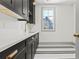 Mudroom with gray cabinets, white countertop and black-and-white tile floor at 375 Chattahoochee St, Roswell, GA 30075