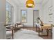 Bright home office featuring hardwood floors, two large windows, stylish desk, and comfortable seating at 375 Chattahoochee St, Roswell, GA 30075