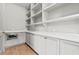 Open pantry boasts extensive white cabinetry, shelving, and a built-in microwave at 375 Chattahoochee St, Roswell, GA 30075