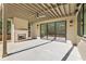 Covered patio featuring concrete floors, stone fireplace, and sliding glass doors at 375 Chattahoochee St, Roswell, GA 30075