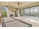 Covered patio with stone fireplace, fan, and sliding glass doors to the interior at 375 Chattahoochee St, Roswell, GA 30075