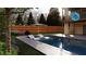 Inviting backyard pool with chairs in the water and landscaped surroundings at 375 Chattahoochee St, Roswell, GA 30075