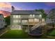 Charming backyard at twilight, featuring a screened porch, deck, and vibrant green grass at 1037 Panoramic Pte, Buford, GA 30518