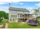 Grassy backyard featuring a large deck, trampoline, and peaceful outdoor space at 1037 Panoramic Pte, Buford, GA 30518