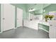 Updated bathroom with double sink vanity, gray hexagonal tile flooring, and green paint at 1037 Panoramic Pte, Buford, GA 30518