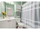 Bathroom with white vanity, and a white and gray striped shower curtain at 1037 Panoramic Pte, Buford, GA 30518