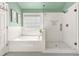 Stylish bathroom with soaker tub, glass enclosed shower, and neutral colors at 1037 Panoramic Pte, Buford, GA 30518