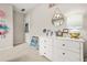 Bright bedroom with a white dresser, round mirror, and neutral-toned walls and carpet at 1037 Panoramic Pte, Buford, GA 30518