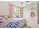 Bedroom with ceiling fan, large windows with pink curtains, and light-colored carpet at 1037 Panoramic Pte, Buford, GA 30518
