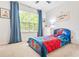 A themed bedroom with a Spider-Personal bed, blue curtains, and a view of the outdoors at 1037 Panoramic Pte, Buford, GA 30518