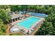 An inviting community pool area with plenty of lounge chairs, seating, and a hot tub at 1037 Panoramic Pte, Buford, GA 30518